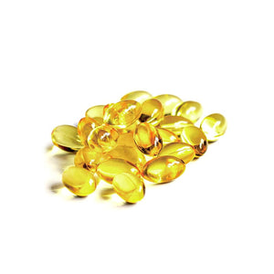 Pile of golden liquid-filled hemp oil softgel capsules on a white background.